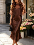 Front close view of chocolate-brown satin-look midi dress with sheer cape overlay, deep V bodice and flowing hem