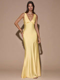 Pale yellow satin maxi dress with deep V neckline and wide straps