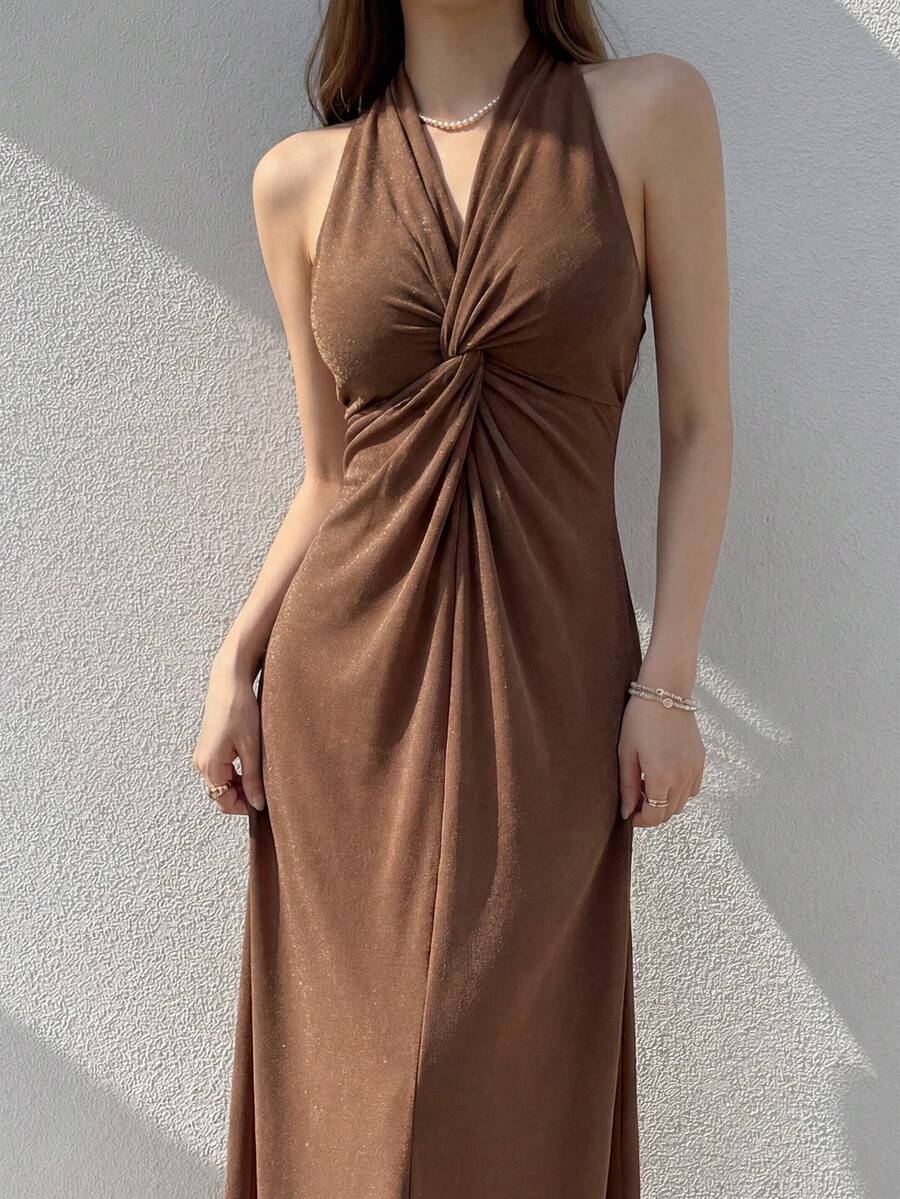 Outdoor close front view of coffee-brown halter maxi dress with central bust twist