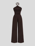 Front full-length view of coffee-brown halter jumpsuit with lace neckline, ruched waist and wide legs