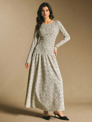 Front view of a cream and black horizontally striped long-sleeve maxi dress with fitted bodice, button placket, and full skirt