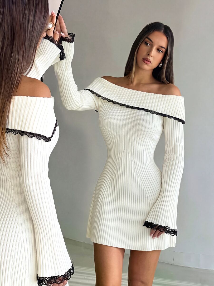 Angled close view of ribbed bodice and contrast black lace on cream dress