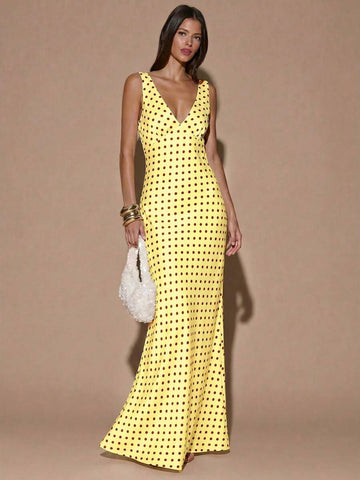 Front view of yellow with dark polka dots sleeveless deep V-neck maxi dress with crossed open back, shown for wedding and evening wear