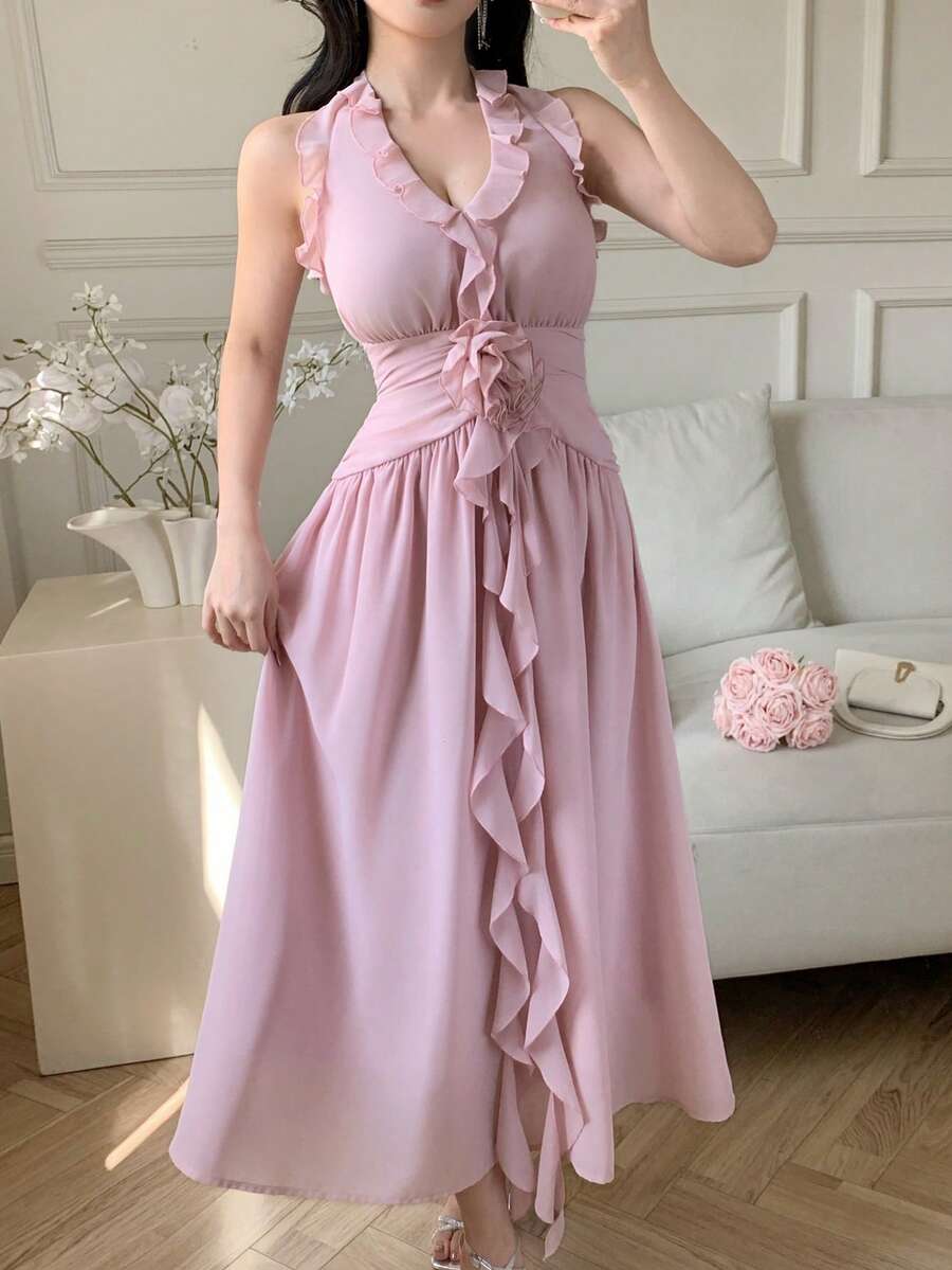 Pale pink sleeveless halter dress with waist rose and flowing skirt