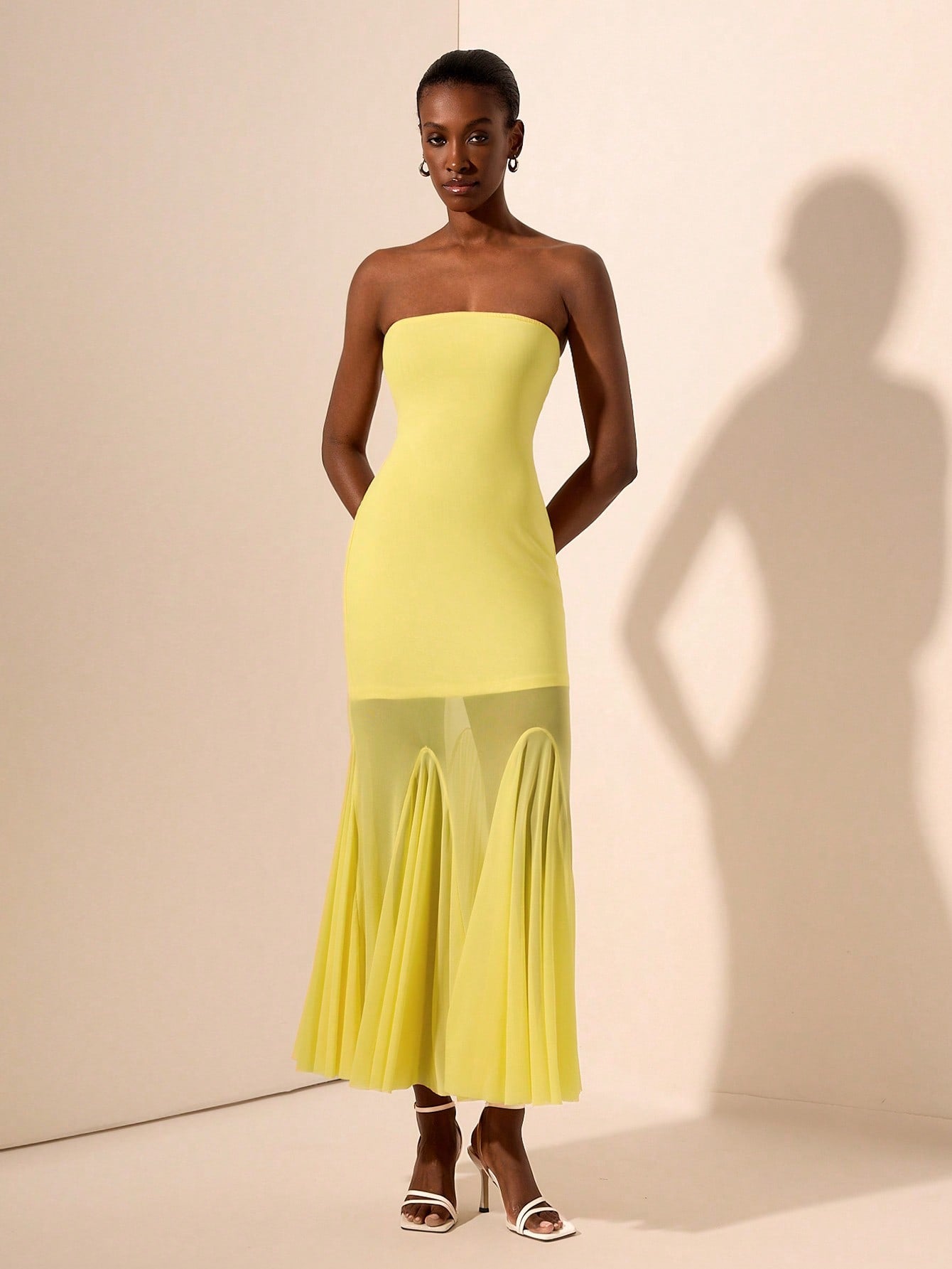 Turn heads in this playful yellow strapless mermaid maxi dress, designed to dazzle all night long. Featuring a unique knit texture and sheer mesh accents, it perfectly blends elegance with an edgy vibe. The figure-hugging silhouette flatters your curves while the vibrant yellow hue adds a burst of sunshine to your evening look. Ideal for making unforgettable entrances and sparkling under the lights.