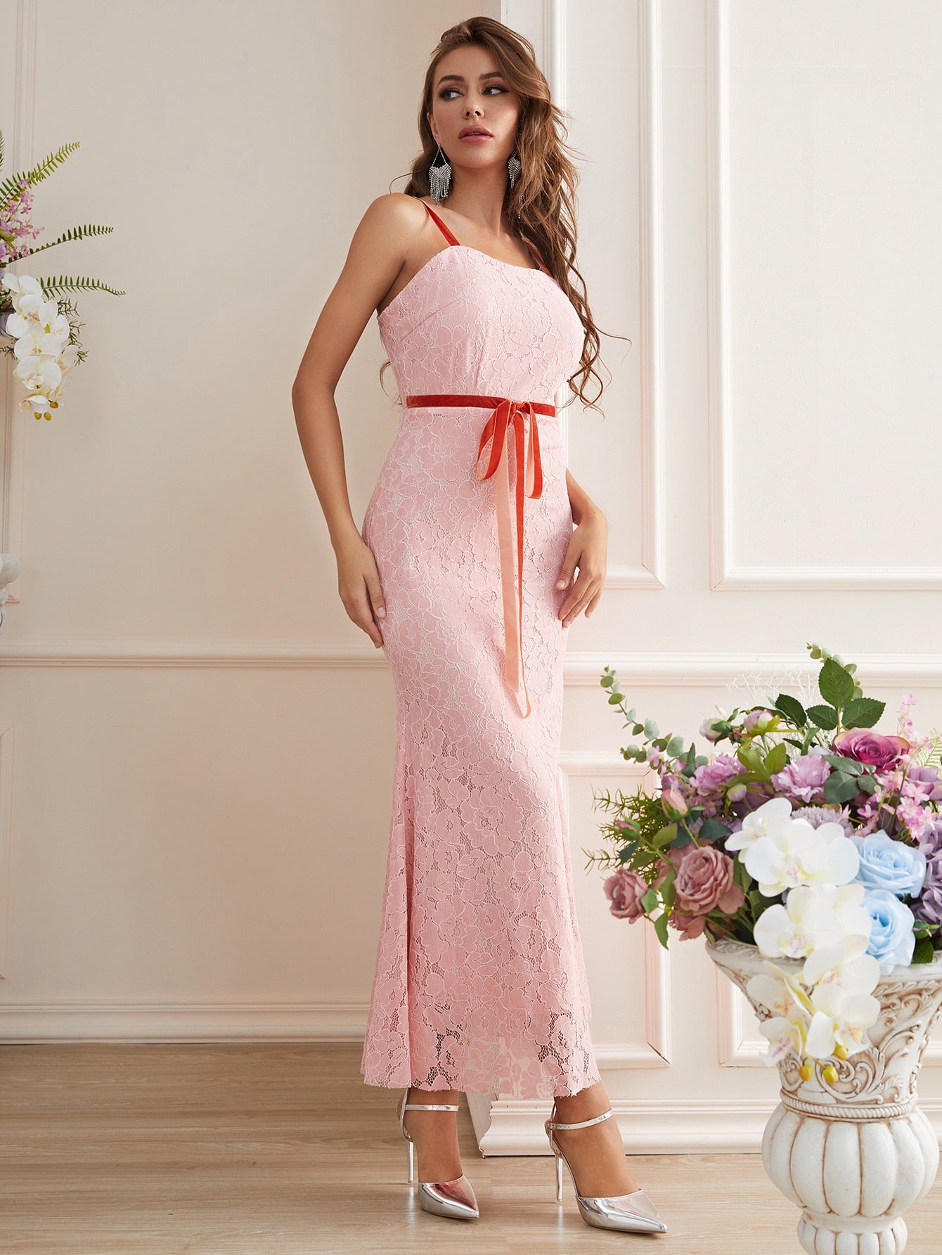 Step into the spotlight in this show-stopping lace dress that's equal parts romance and drama. The delicate tie-front detail adds a flirty touch, while the mermaid hem creates an elegant silhouette that hugs your curves before flaring out with flair. Perfect for galas, weddings, or any occasion where you want to turn heads and feel absolutely fabulous. This is the dress that makes you the main character of the evening.