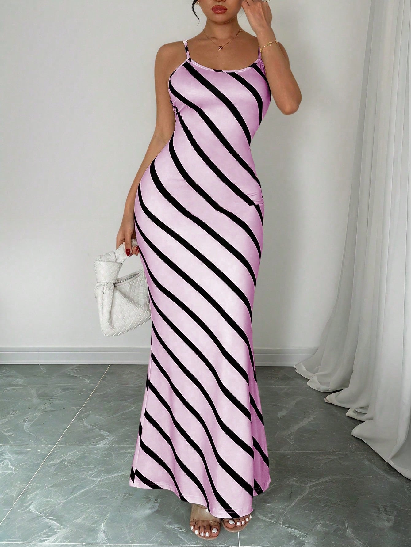 Get ready to turn heads in this elegant extra long purple striped dress! Perfect for both commuting and special occasions, this fitted dress features a flattering strap design that will highlight your figure. Whether you're on the go or dressing up, this dress is sure to make a statement.