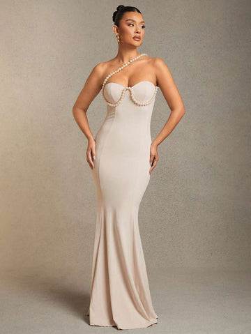 Make a splash at your next event in this show-stopping mermaid dress! Featuring an eye-catching faux pearl bustier that catches the light beautifully, this gown hugs your curves in all the right places before flowing into a dramatic fishtail hem. Perfect for galas, proms, or any occasion where you want to turn heads and feel absolutely fabulous. The elegant silhouette flatters your figure while the shimmering pearl details add that extra touch of glamour. Dive into sophistication and let your inner mermaid 