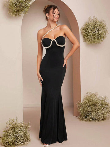 Elevate your evening elegance with this stunning mermaid dress, featuring a structured bustier bodice adorned with lustrous faux pearl embellishments. The form-fitting silhouette gracefully hugs your curves before flowing into a dramatic fishtail hem, creating a show-stopping silhouette perfect for galas, proms, and formal events. The pearl detailing adds sophisticated glamour and catches light beautifully throughout the night.