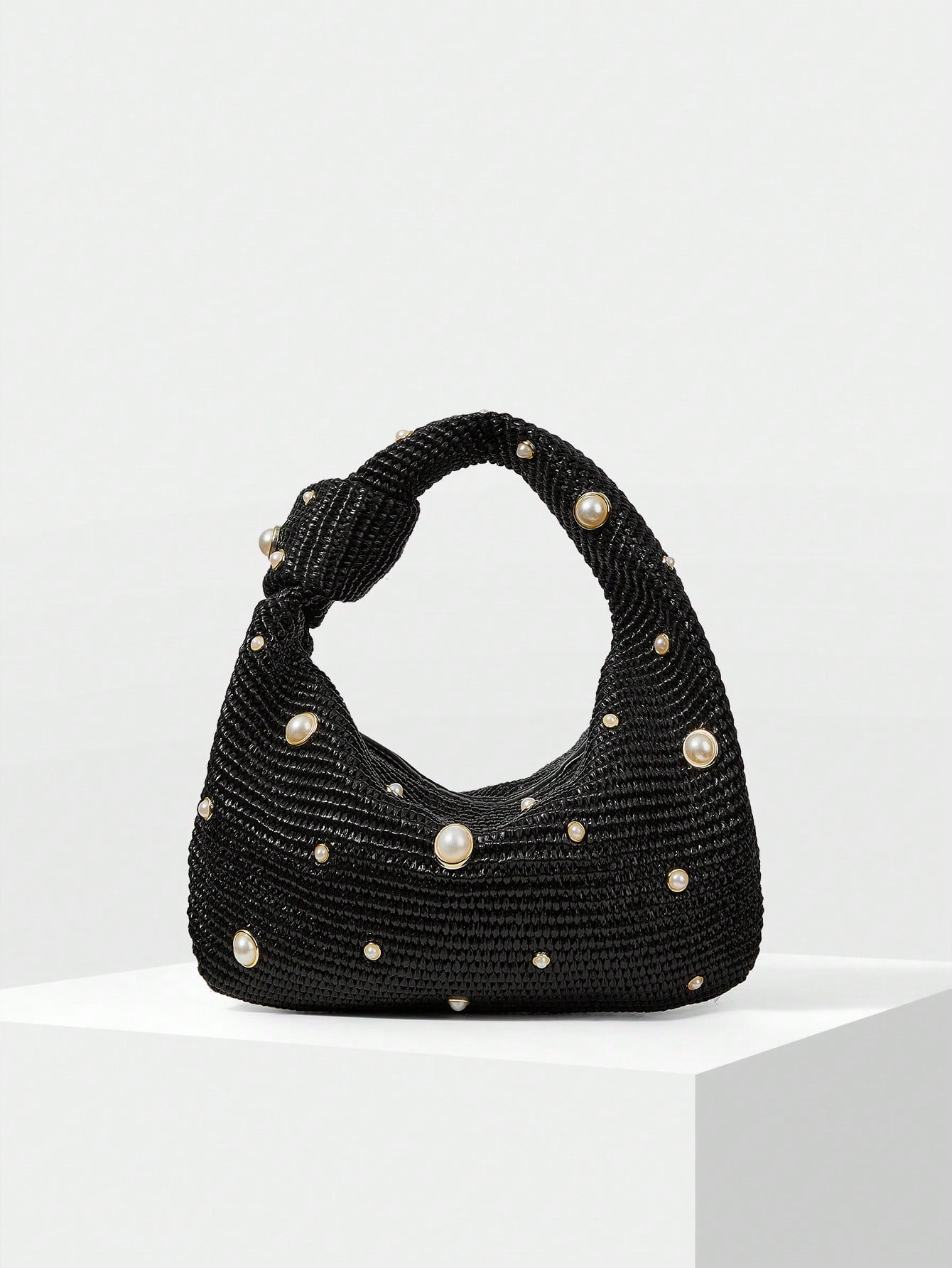 Add a touch of whimsy to your outfit with this Elegant Faux Pearl Embellished Top Handle Bag. Its charming pearl details bring a playful sparkle, while the sturdy top handle keeps your essentials close and stylish. Perfect for turning heads and brightening any look!