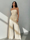 Make an unforgettable impression in this Elegant Floral Embroidered Mesh Crop Top and Pants Set. Tailored for petite frames, this sophisticated all-white ensemble combines timeless elegance with modern flair. The strapless bandeau crop top features exquisite floral embroidery with asymmetrical lace-up detailing and charming puff sleeves. Paired with high-waisted slim-fit long pants, this set creates a refined, coordinated silhouette perfect for weddings and celebrations. 