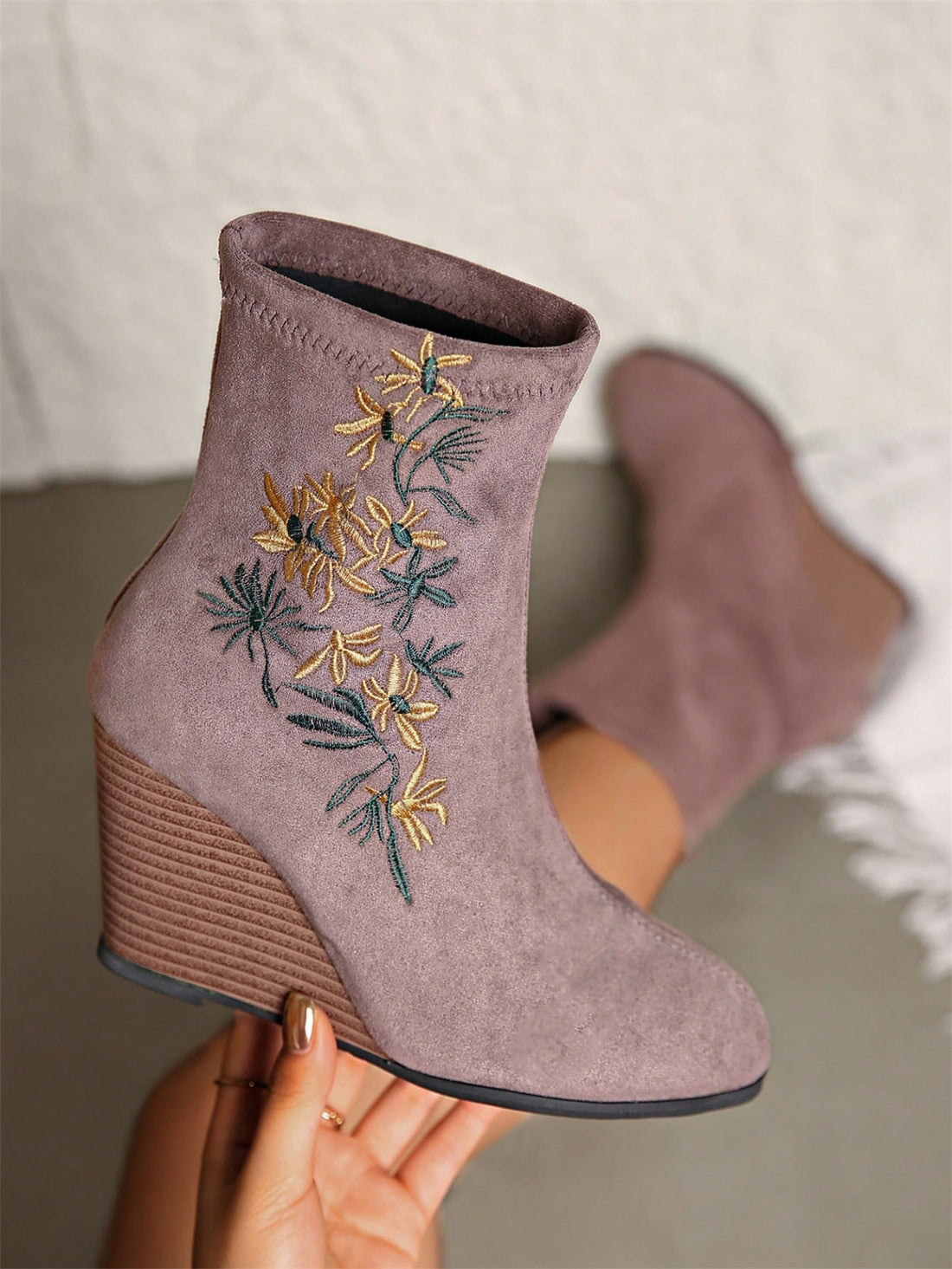 Elevate your style with our Elegant Floral Embroidery Suede Wedge Heel Ankle Boots! Featuring a beautifully embroidered design and a comfortable wedge heel, these boots are both elegant and practical. Perfect for any occasion, they will add a touch of sophistication to any outfit.