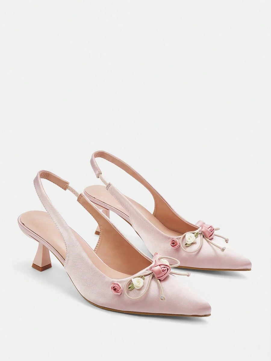 Step into elegance with these stunning floral high heels, designed for women who want to make a lasting impression. Featuring a delicate pointed toe and graceful mid-height pyramid heel, these slingback pumps offer the perfect balance of comfort and sophistication. Crafted from luxurious satin with a soft PU leather lining, these baby pink beauties are adorned with charming floral details and a feminine bow accent. Ideal for summer weddings, graduations, and special occasions.