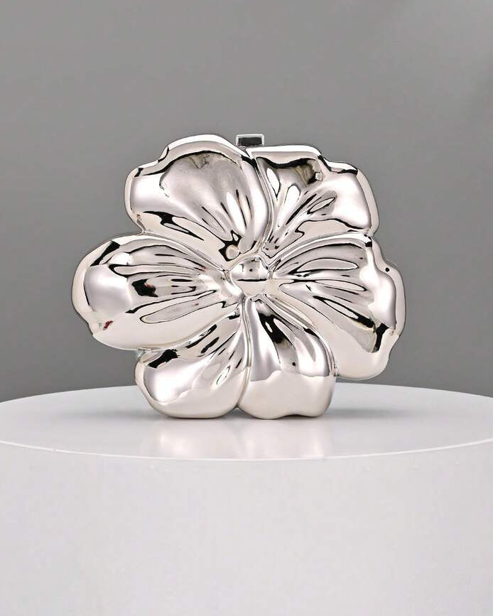 Elevate your evening with this stunning floral metal clutch bag, designed for those unforgettable moments. Crafted from premium PMMA with elegant ironmongery details, this mini box bag features a glamorous silver finish that catches the light beautifully. Perfect for weddings, parties, and special occasions, it combines luxury with practicality. The compact size fits essentials while making a sophisticated statement. An ideal accessory for anyone seeking refined elegance and timeless style.