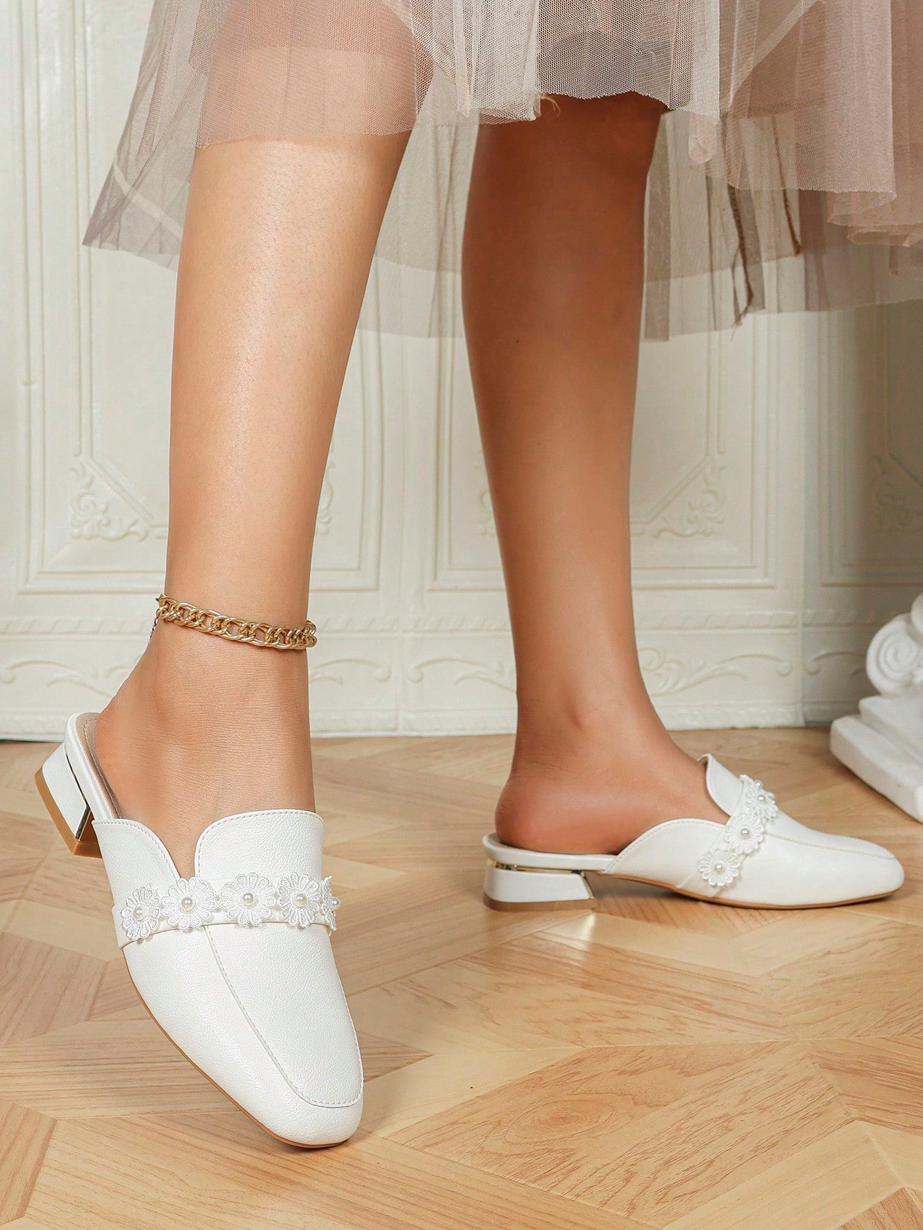 Step into sophistication with these Elegant Floral Pearl Mules, designed for women who value both style and comfort. Featuring a mid block heel, these slip-on shoes offer stable support ideal for daily spring commutes. The delicate floral embellishments paired with subtle pearl details add a refined touch, making them versatile for work or casual outings. Their easy slip-on design ensures convenience without compromising elegance, perfect for those seeking a blend of fashion and practicality.