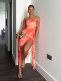 Front view of coral floral strapless ruched midi dress with side ruffle slit