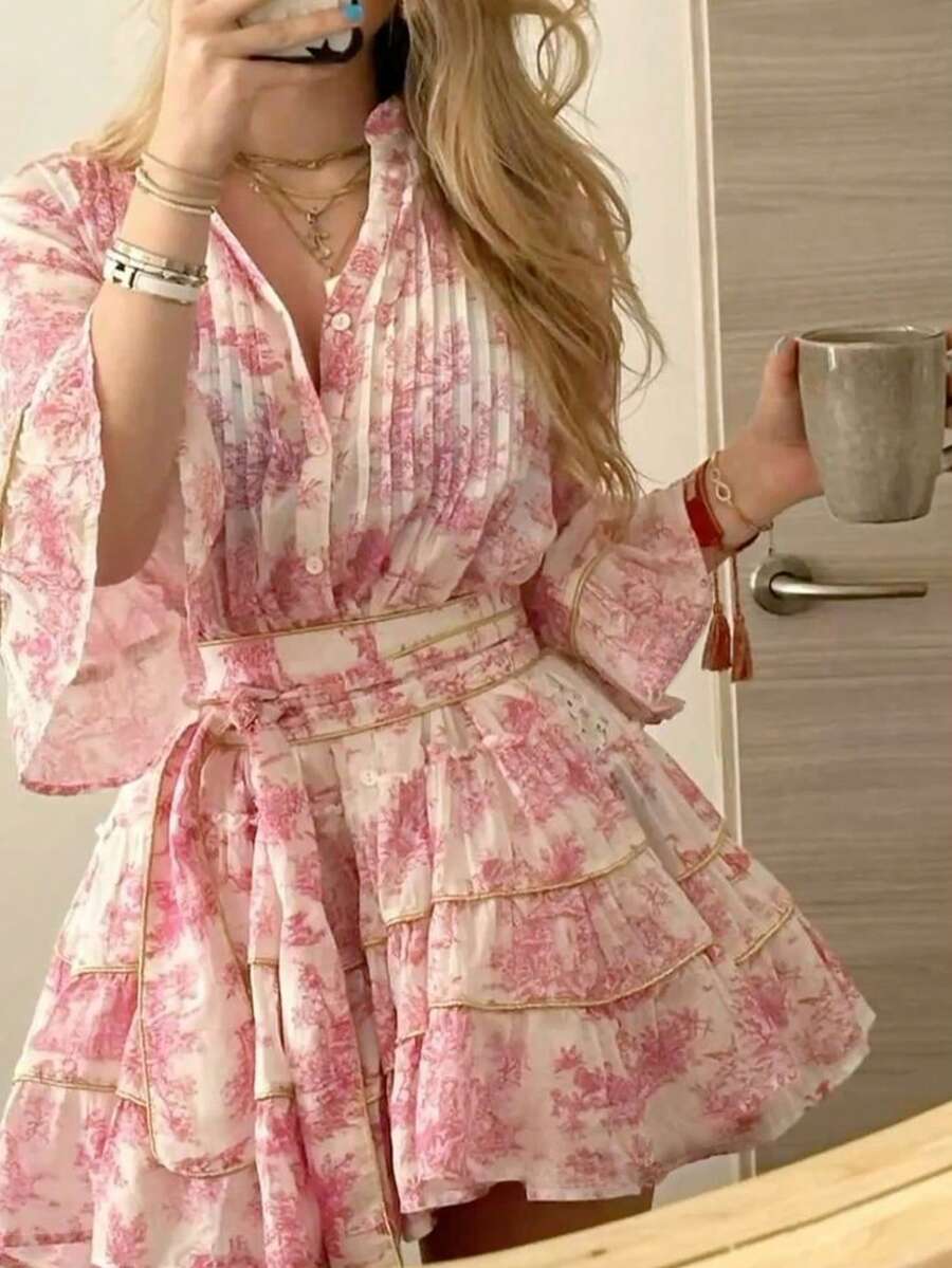 Embrace effortless elegance with this charming floral print button-front dress, designed for romantic getaways and casual adventures. The notched neckline and three-quarter flare sleeves create a flattering silhouette, while the high-waisted A-line cut offers comfortable all-day wear. Layered ruffle hem and knot details add playful boho flair. Crafted from soft woven polyester-elastane blend in a lovely pink hue, this dress transitions seamlessly from beachside strolls to evening dinners. 