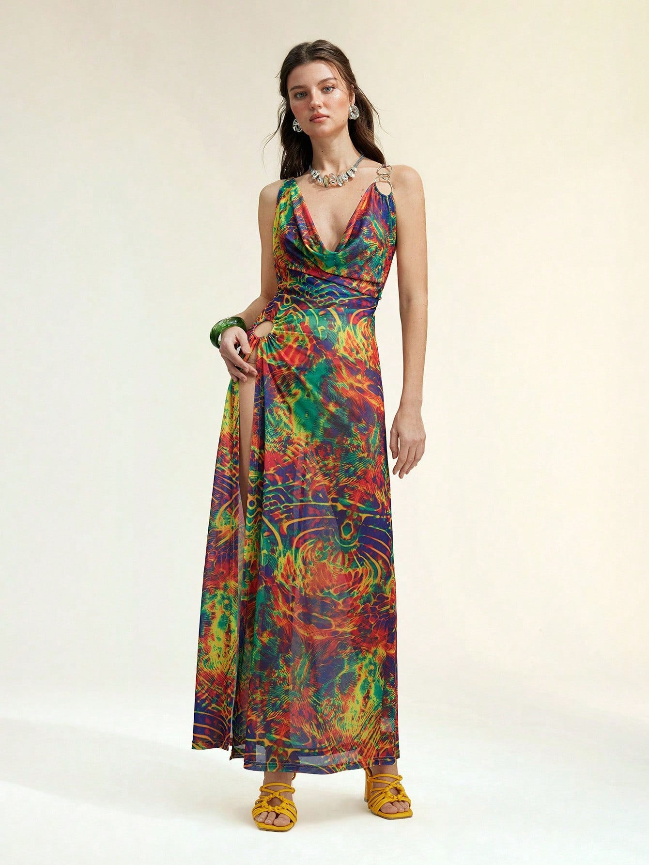 Step into summer with this playful floral print mesh maxi dress. Featuring a draped neck and a daring backless design, it’s perfect for vacation days filled with sunshine and breezy evenings. Lightweight and flowy, this dress combines elegance with comfort, making every moment feel like a stylish getaway.