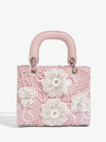 Expertly designed for elegant occasions, this Floral Top Handle Evening Bag will elevate your style at weddings, parties, and special occasions. With its delicate floral details and convenient top handle, this bag is both beautiful and practical. Make a statement with this must-have accessory.
