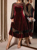 Front view of burgundy velvet-look A-line midi dress with sheer polka-dot mesh sleeves and hem panels