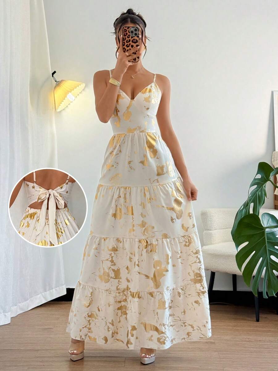 The perfect dress for a chic and playful look on your spring/summer vacations! This elegant French style dress features a stunning gold foil print and a flared design that will surely make you stand out. Embrace the quirky and fun side of fashion with this must-have piece!