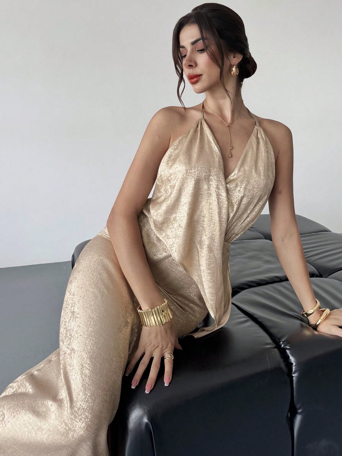 Slip into pure glamour with this stunning gold satin halter dress that's ready to turn heads at any event. The silky smooth fabric drapes beautifully while the daring backless design adds just the right amount of allure and sophistication. Perfect for parties, galas, or those nights when you want to feel absolutely fabulous. This versatile piece transitions seamlessly from cocktail hour to dancing the night away. Elevate your evening wardrobe with a dress that's equal parts elegant and unforgettable.