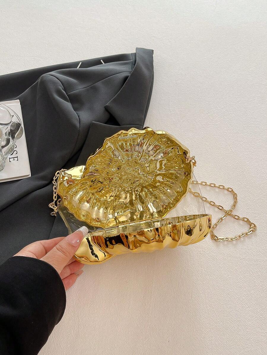 Add a splash of seaside charm to your evening look with this elegant golden conch-shaped shoulder bag. Its shimmering finish and unique shell design make it a standout accessory, while the detachable strap lets you switch from shoulder to clutch in a snap. Perfect for turning heads and carrying your essentials with a playful twist on sophistication.