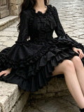 Three-quarter front view of black gothic Lolita dress with tiered ruffles and bell sleeves