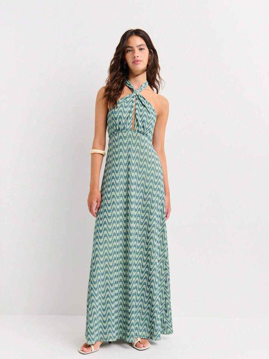 Dive into summer style with this stunning green jacquard halter dress! The mesmerizing wavy pattern adds movement and visual interest, while the flattering halter neckline keeps things chic and sophisticated. Whether you're lounging by the pool, exploring a new destination, or turning heads at an evening soirée, this versatile piece transitions effortlessly from day to night. The jacquard fabric brings texture and dimension that photographs beautifully, making it your new go-to for vacation snapshots and sp