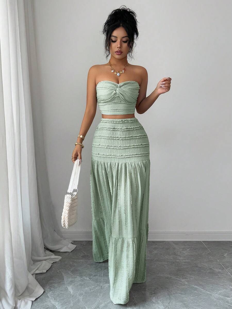 Elevate your wardrobe with this sophisticated two-piece set featuring a cropped knitted jacquard top and flowing loose skirt in rich green. The twist front detail on the top adds an elegant touch, while the jacquard knit texture brings visual interest and dimension. 
