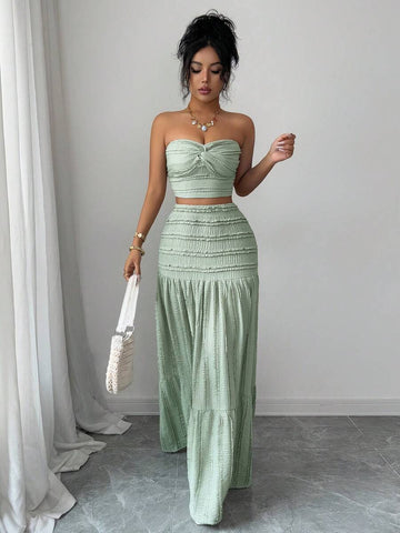 Elevate your wardrobe with this sophisticated two-piece set featuring a cropped knitted jacquard top and flowing loose skirt in rich green. The twist front detail on the top adds an elegant touch, while the jacquard knit texture brings visual interest and dimension. 
