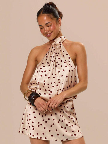 Step into the spotlight with this playful satin mini dress, featuring a chic halter neck and timeless polka dots. Perfect for birthdays, graduations, and sunny celebrations, its smooth fabric and flirty cut keep you comfortable and stylish all day and night. Celebrate in a dress that’s as fun and fabulous as the occasion!