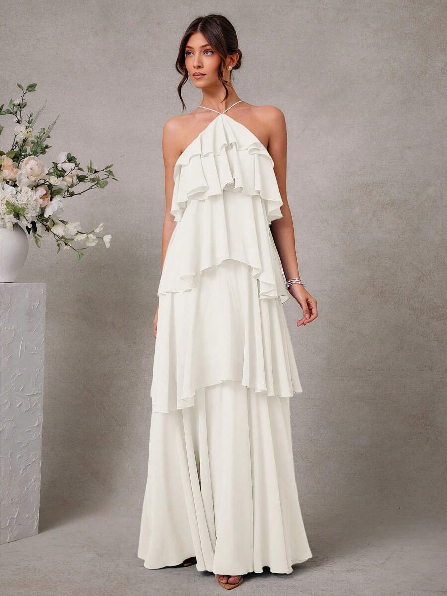 Turn heads at any wedding with this Elegant Halter Neck Tiered Chiffon Maxi Dress. Its flowing chiffon and tiered layers create a dreamy silhouette that dances with every step. The halter neck adds a flirty touch, making it perfect for romantic celebrations. Feel effortlessly graceful and ready to mingle all night in this charming maxi dress designed for memorable moments.