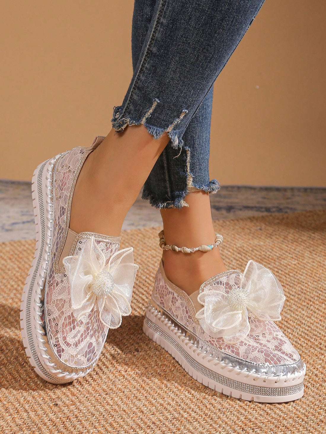 Step into effortless style with these charming handmade floral mesh sneakers. Crafted with breathable mesh fabric, they're perfect for keeping your feet cool during vacations, parties, or everyday adventures. The slip-on design means zero fuss—just slide them on and go. Featuring delicate floral details in a versatile beige tone, these sneakers blend comfort with understated elegance. Whether you're exploring a new destination or dancing the night away, these casual kicks deliver the perfect balance of play