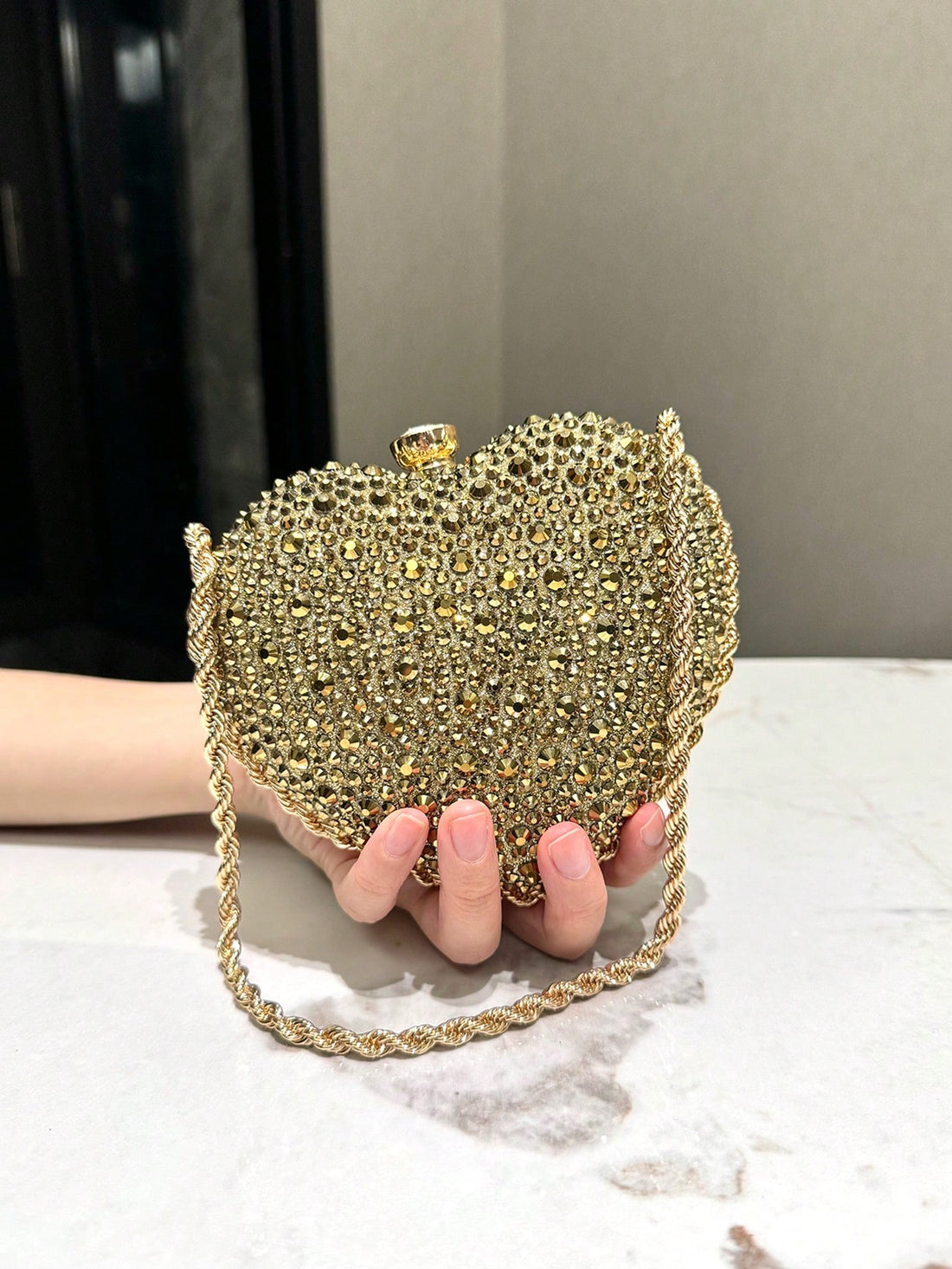 As an industry expert, I recommend the Elegant Heart-Shaped Gold Crystal Clutch Bag for Sophisticated Evenings. Made with gold crystal, this clutch is both elegant and sophisticated, perfect for formal events. Its heart-shaped design adds a touch of romance, allowing you to make a statement wherever you go.