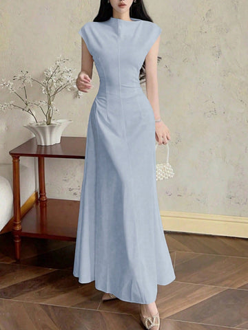 Make a statement at your next formal event with this head-turning asymmetric flared gown! The high collar adds a touch of sophistication, while the sleeveless design keeps you cool on the dance floor. This dress doesn't just fit—it flatters, with a playful asymmetric cut that swishes and sways with your every move. Who said formal had to be boring?