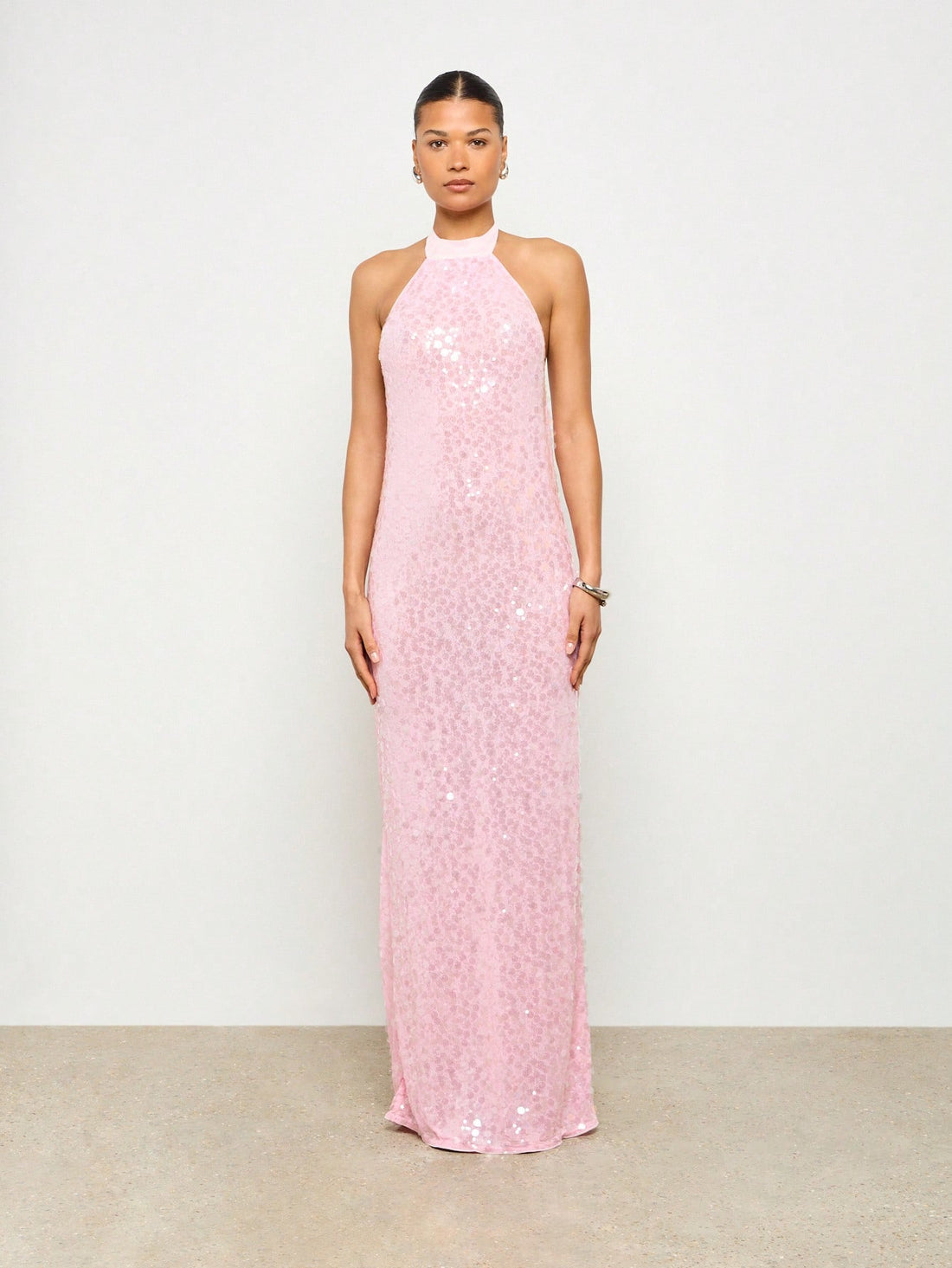 Turn heads effortlessly in this Elegant High Halter Neck Sequin Maxi Dress. Its shimmering sequins catch every light, while the playful cowl back adds a flirty twist to your evening style. Perfect for dancing the night away or making a sparkling entrance, this dress ensures you shine with confidence and grace.