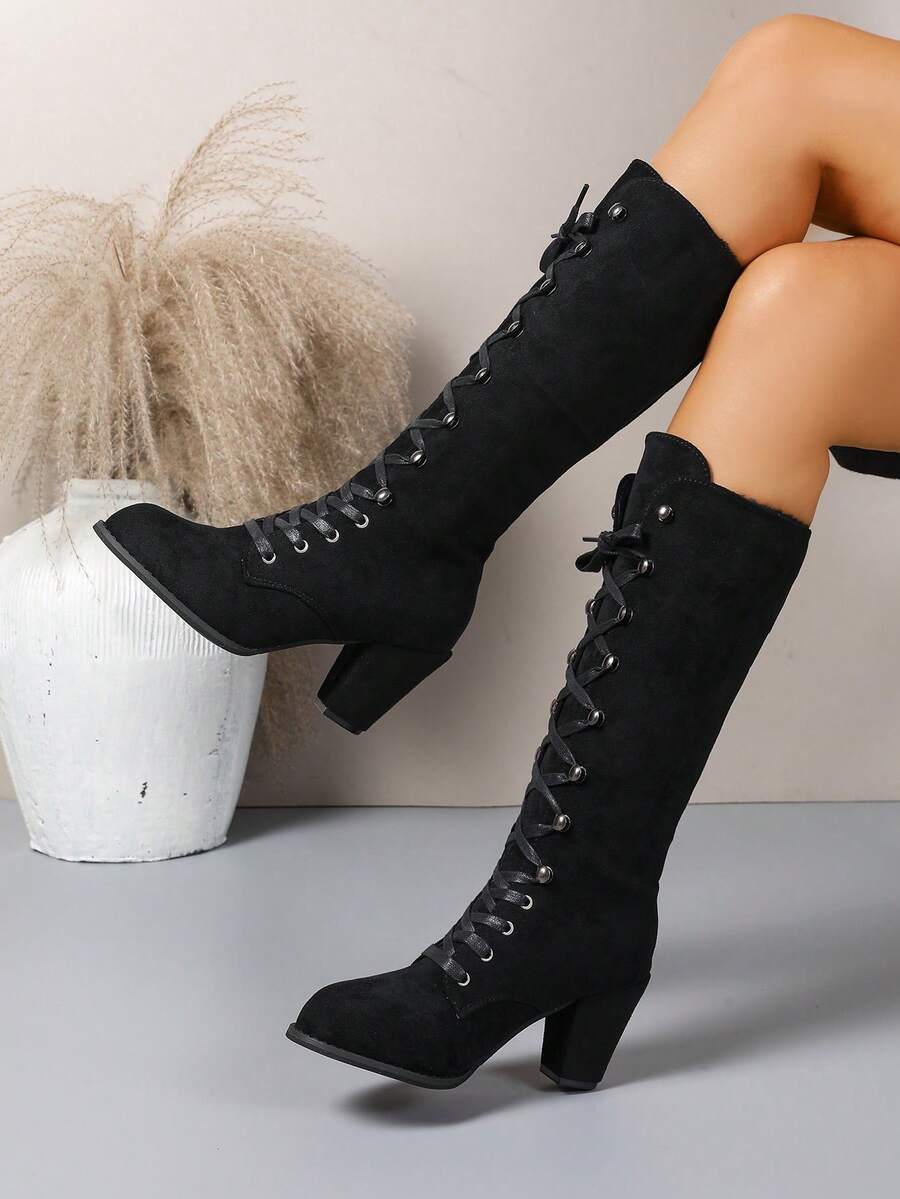 Step out in style with these elegant knee-high commuter boots! Featuring a sturdy chunky heel and eye-catching metal eyelets, they bring a playful edge to every outfit. Designed to keep you comfy and chic all year round, these boots are perfect for turning heads whether you're at work or a special event. Elevate your shoe game with a pair that's as versatile as your busy lifestyle!