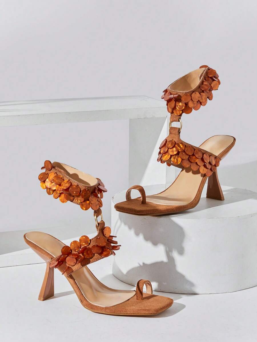 Elevate your summer style with these sophisticated ankle strap stiletto sandals. Featuring delicate shell ornaments and a minimalist design, they strike the perfect balance between elegance and simplicity. The sleek stiletto heel adds instant glamour to any outfit, while the secure ankle strap ensures comfort throughout the day. Perfect for special occasions, romantic getaways, or making a statement at summer events. A timeless piece that transitions effortlessly from day to evening wear.