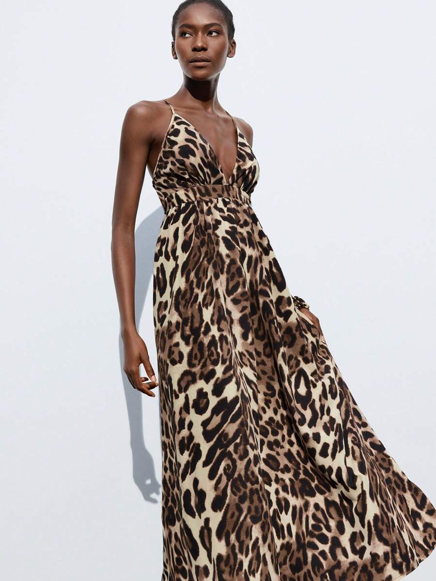 Turn heads in this stunning leopard print maxi dress that's equal parts wild and sophisticated. The daring backless design creates an effortlessly chic silhouette, while the flowing fabric moves beautifully whether you're strolling the beach, dancing at a party, or soaking up vacation vibes. This versatile piece transitions seamlessly from day to night—throw on sandals for casual elegance or pair with heels for an unforgettable evening look. The timeless leopard pattern adds just the right amount of sass to