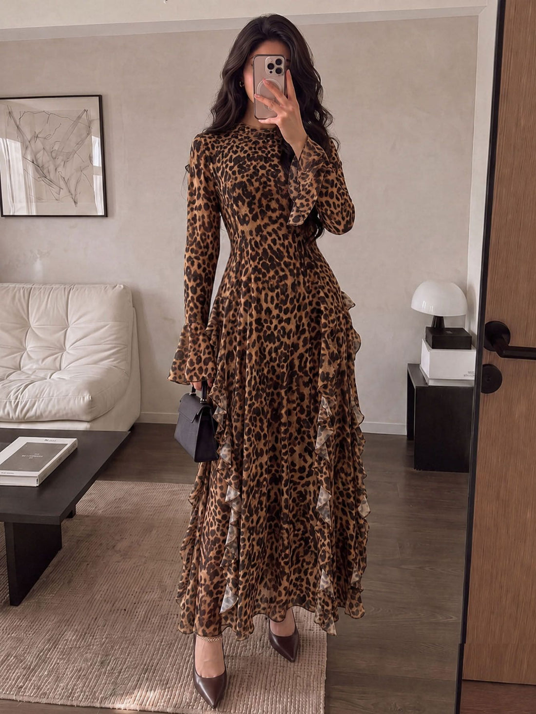 Front view of a woman wearing a brown leopard-print long-sleeve maxi dress with ruffled skirt and flounced cuffs