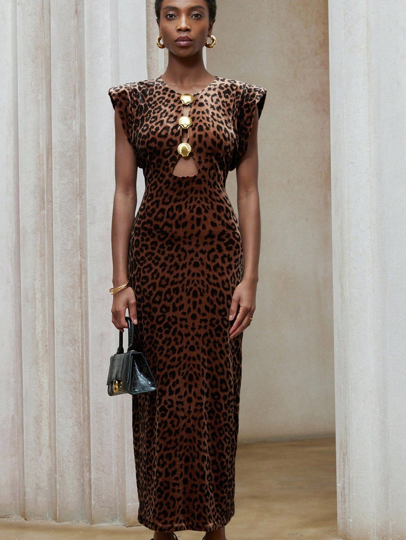 Turn heads in this playful leopard print velvet dress, designed with bold exaggerated shoulders and a chic metal buckle detail. Its soft velvet fabric feels luxurious while adding a touch of wild sophistication. Perfect for making a confident statement at any party or night out. Let your fierce side shine with effortless style and flair.