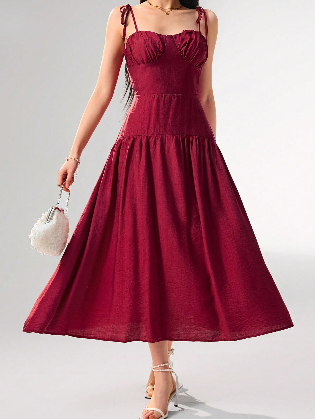 Get ready to turn heads with this elegant and playful camisole dress! The ruffle shoulders add a touch of fun while the knot detail cinches the waist for a flattering silhouette. Perfect for any occasion, this dress comes in a variety of solid colors that are sure to make a statement.