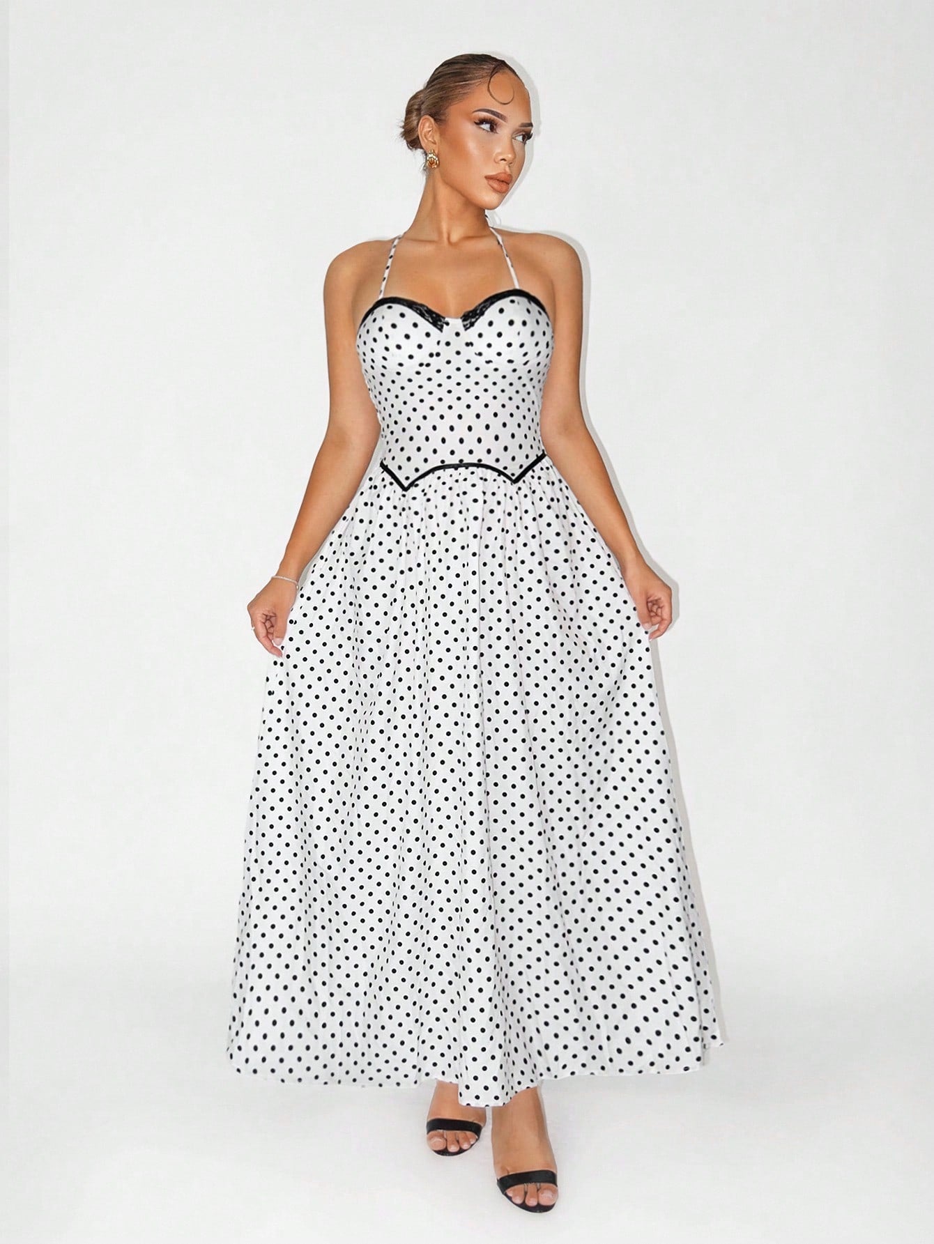 Twirl into vacation mode with this stunning long polka dot dress that effortlessly blends timeless elegance with playful charm. The classic black and white palette pairs perfectly with any occasion—from beachside getaways to evening soirées. Crafted for comfort and style, this dress features a flattering silhouette that moves beautifully with you. Whether you're sipping cocktails by the pool or exploring a new destination, this versatile piece is your go-to for looking polished and put-together. Pack it, we