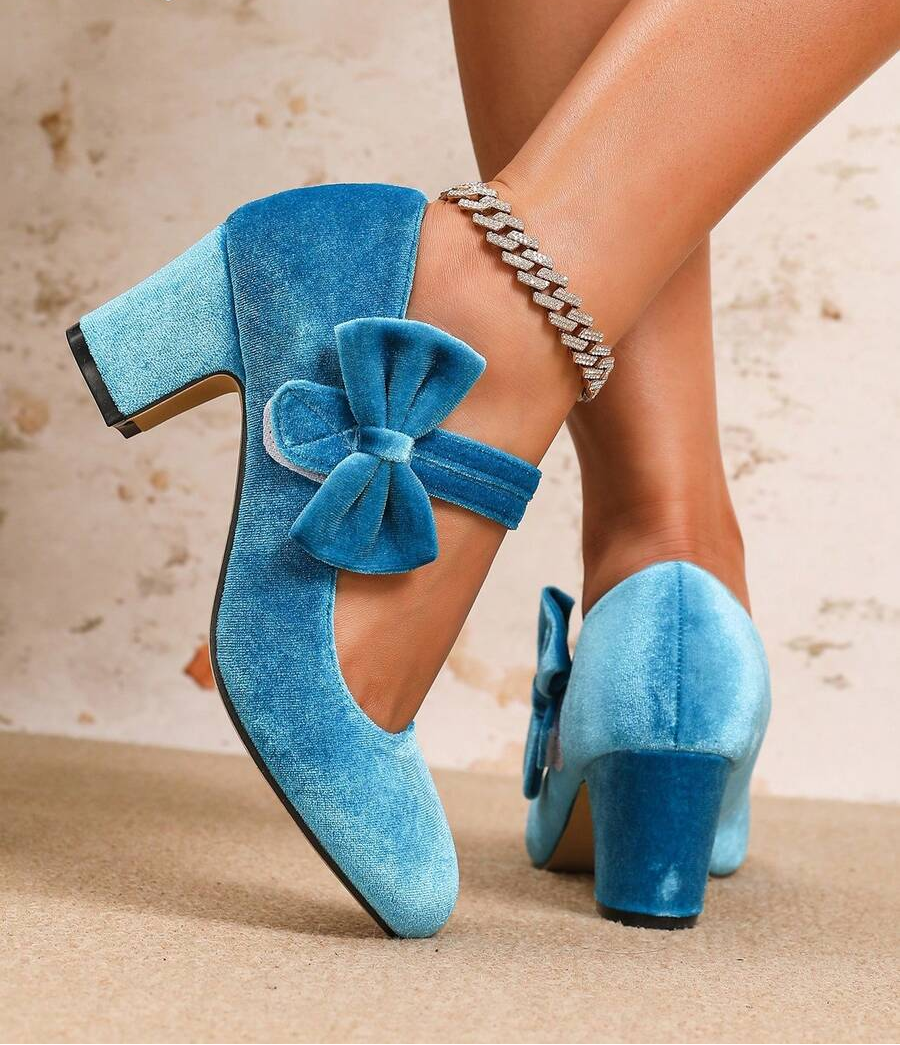 Step into sophistication with these charming Mary Jane heels that blend timeless elegance with modern flair. Crafted from luxurious velvet, they feature a delicate bow accent and rounded toe for all-day comfort. Whether you're dancing at a wedding, hosting a party, or elevating your everyday look, these versatile heels deliver instant polish. The classic Mary Jane strap keeps your foot secure while the refined silhouette flatters any outfit. A must-have for anyone who loves shoes that work as hard as they d