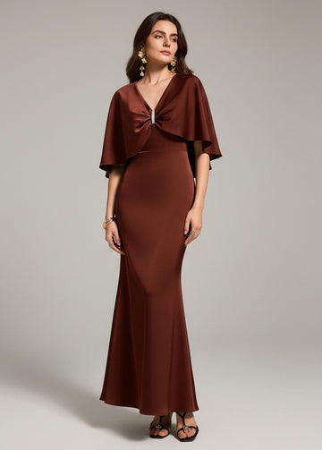 Dive into elegance with this stunning mermaid dress featuring a dramatic cloak-style design that turns heads at every celebration. The flowing silhouette hugs your curves beautifully before cascading into a mesmerizing fishtail hem, while the attached cloak adds an enchanting, otherworldly flair. Perfect for ringing in the New Year, celebrating Valentine's Day, or making a splash at any special occasion, this dress combines sophistication with a touch of whimsy. Whether you're dancing the night away or maki