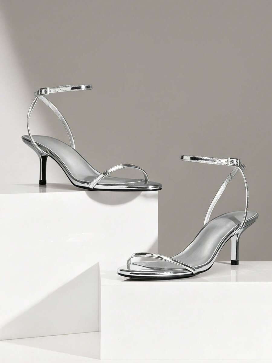 Step into sophistication with these stunning metallic ankle strap stiletto heels. Crafted for the modern woman who demands elegance, these sandals feature a sleek metallic finish that catches the light with every stride. The secure ankle strap ensures comfort and stability, while the elevated stiletto heel adds instant glamour to any occasion. Perfect for summer evenings, special celebrations, or Valentine's Day moments, these heels transition seamlessly from day to night. 