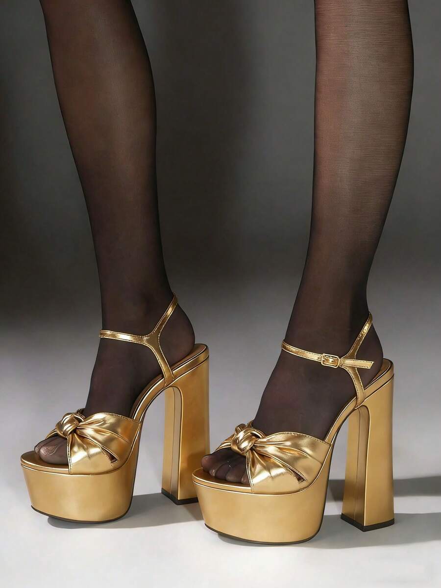 Step into the spotlight with these elegant metallic bow heels, the ultimate statement footwear for parties and high-fashion celebrations. Featuring a dazzling metallic finish that reflects every light, these sandals are adorned with an exquisite, sculptural bow detail for a touch of feminine grandeur. The sturdy chunky high heel provides a confident and stable lift, while the delicate adjustable ankle strap ensures a secure and customized fit for all-night comfort. Perfectly blending bold glamour with sophi