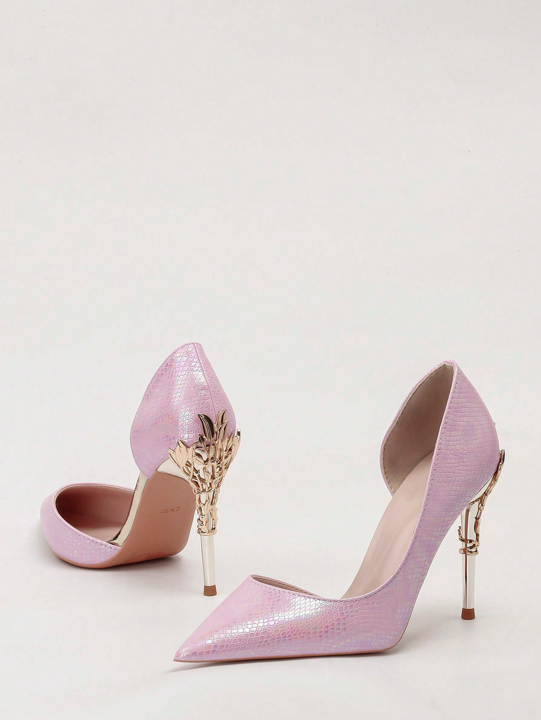 Elevate your special occasion look with our Elegant Metallic Floral Cutout Stilettos. These chic pointed toe heels feature a stunning metallic floral design, perfect for weddings and other formal events. Feel confident and stylish with these statement shoes.