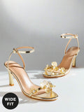 Step into elegance with these stunning metallic gold high-heeled sandals, designed to elevate any occasion. Featuring delicate flower embellishments, these sandals blend sophistication with playful charm. The gleaming gold finish catches the light beautifully, making them a standout choice for parties and special events. Versatile enough for everyday wear, they also bring a touch of glamour to beach outings and casual gatherings. Comfortable and stylish